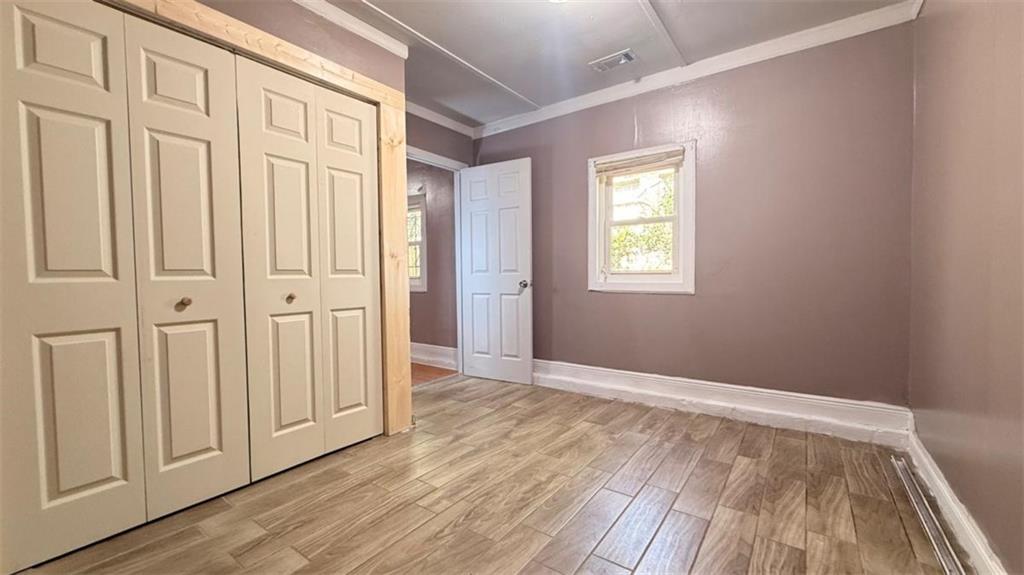 4183 O'Hara Road Forest Park, GA 30297 - Photo 6 of 24 a view of an empty room with wooden floor and a window