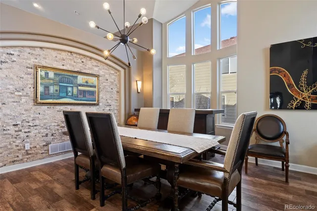 a view of a dining room with furniture and a chandelier