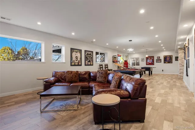 a living room with furniture and a wooden floor
