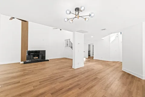 a view of an empty room with a fireplace