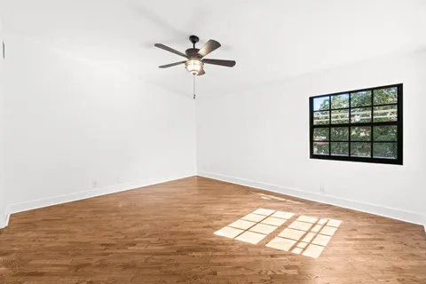 wooden floor in an empty room with a window