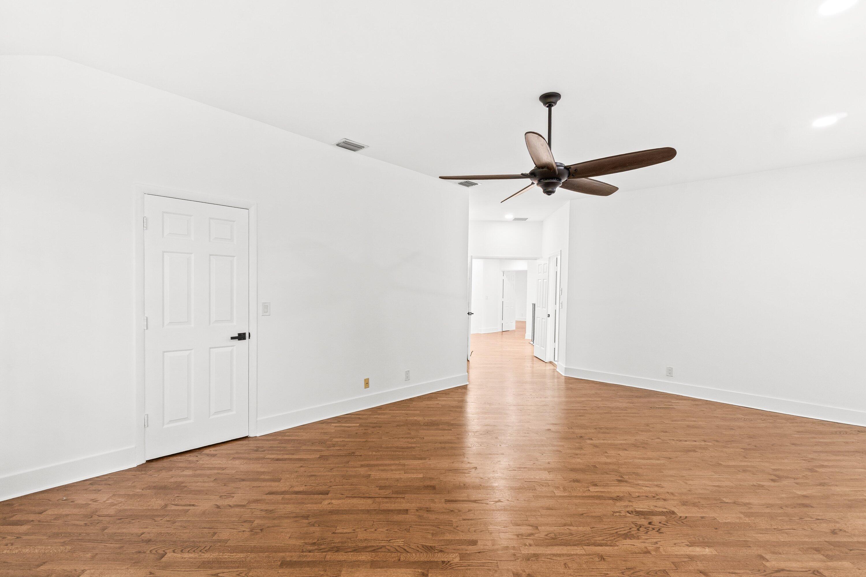 22548 Caravelle Circle, Unit 22548 Boca Raton, FL 33433 - Photo 32 of 40 a view of a room with wooden floor and a ceiling fan