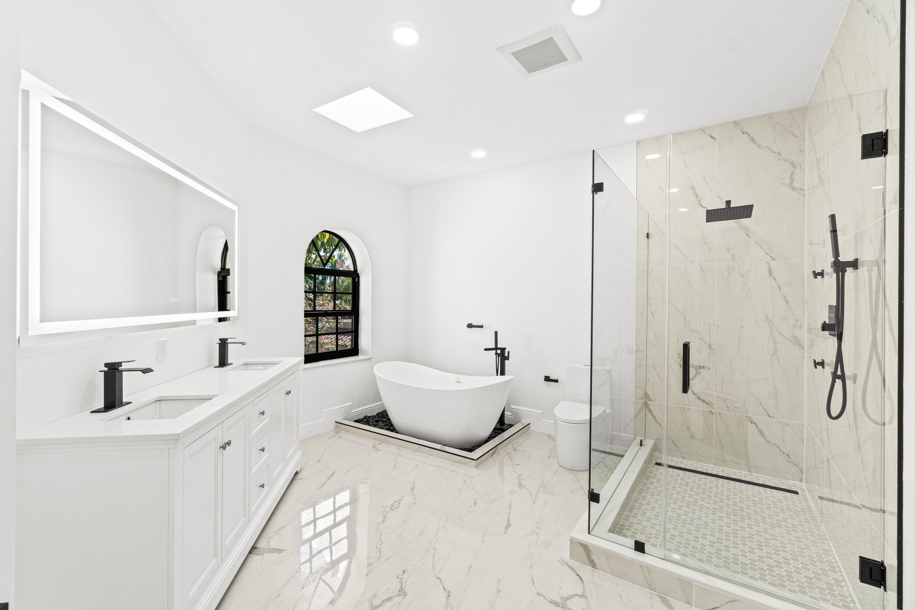 22548 Caravelle Circle, Unit 22548 Boca Raton, FL 33433 - Photo 34 of 40 a en suite bathroom with a double vanity sink a mirror and a shower