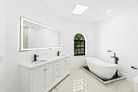a white bath tub sitting next to a shower
