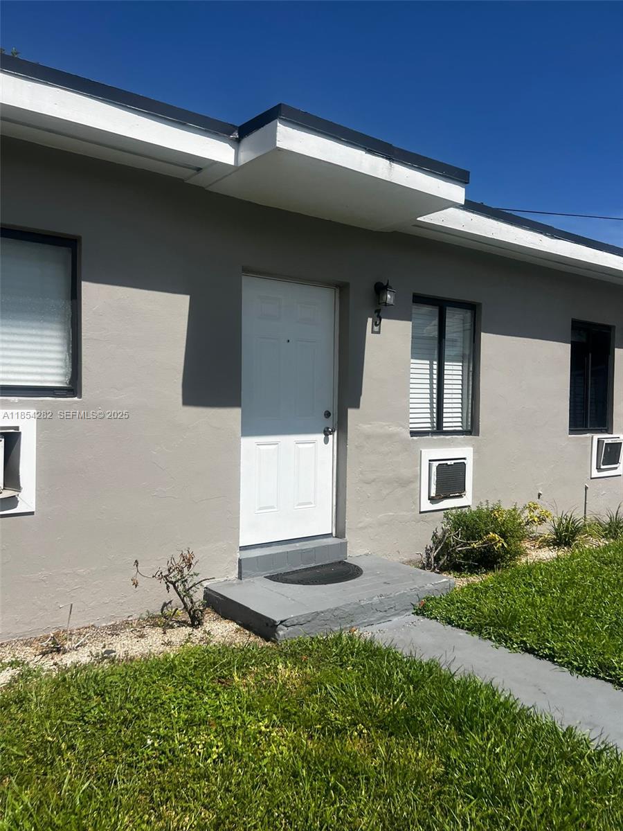 2081 Northwest 30th Street, Unit 3 Miami, FL 33142 - Photo 2 of 10 a front view of house with yard