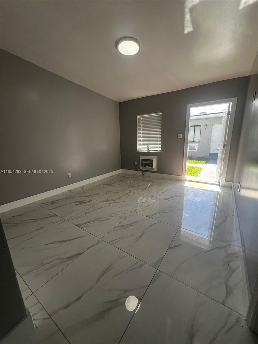 2081 Northwest 30th Street, Unit 3 Miami, FL 33142 - Photo 9 of 10 a view of an empty room with a window
