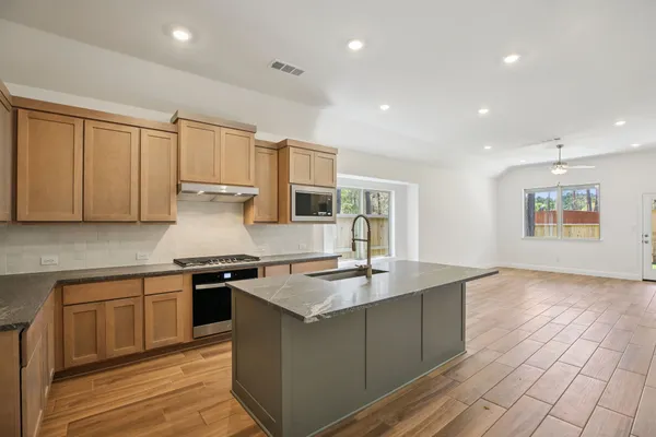 a kitchen with a sink and cabinets