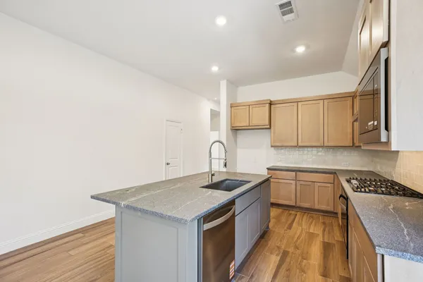 a view of kitchen with sink and wooden floor