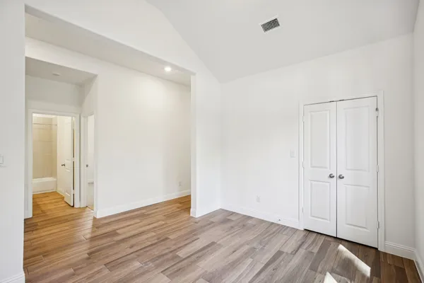 a bathroom with a granite countertop sink toilet a mirror a bathtub and shower
