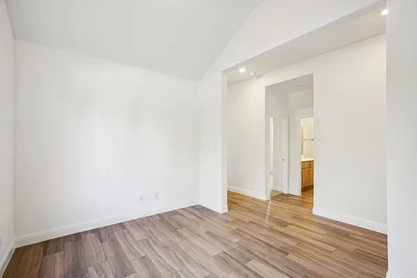 an empty room with a ceiling fan and a window