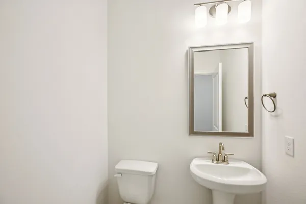 a kitchen with stainless steel appliances granite countertop a sink and a stove top oven with wooden floor