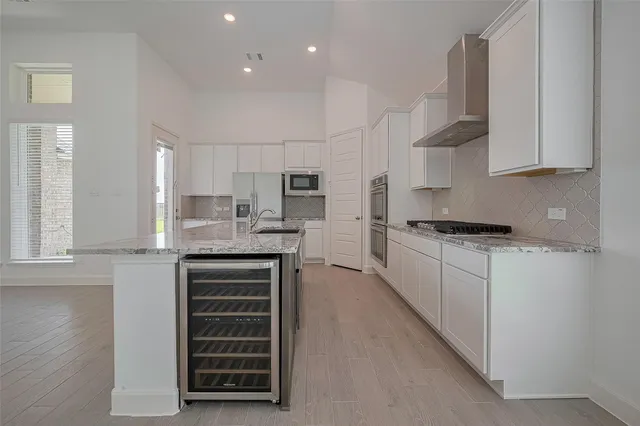 a kitchen with granite countertop a white cabinets and sink