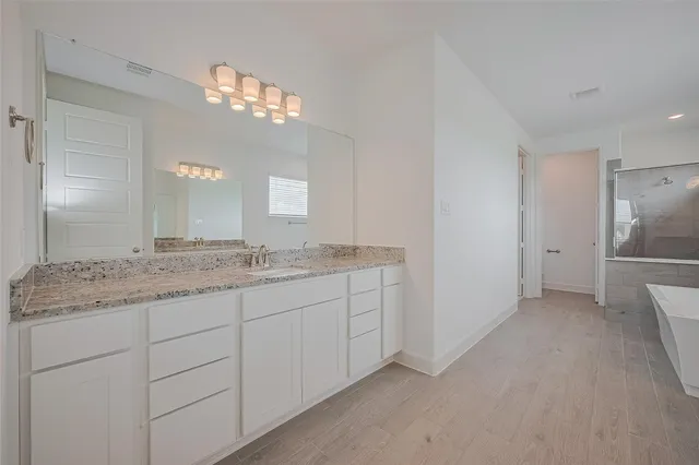 a bathroom with a bathtub and a sink