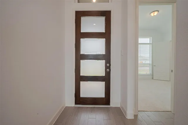 a view of an entryway with wooden floor