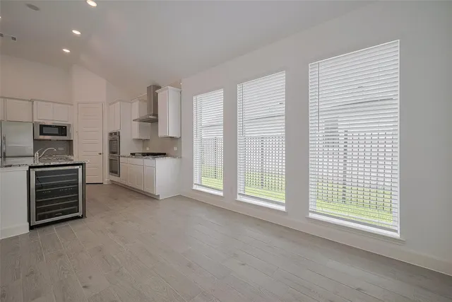 a kitchen with stainless steel appliances a refrigerator and a stove top oven