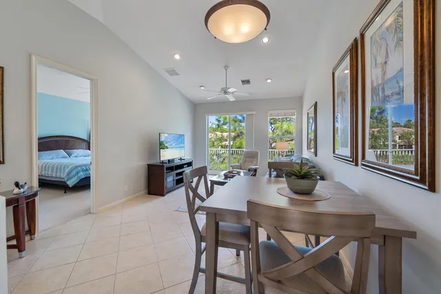 a view of a dining room with furniture and a large window