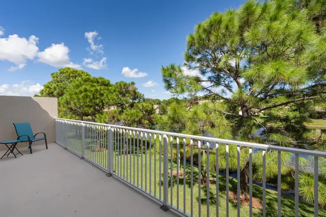 a balcony with trees in the background