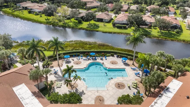 an aerial view of a house with a yard and swimming pool