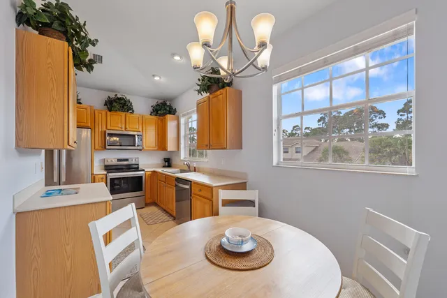 a kitchen with a table chairs stove and refrigerator