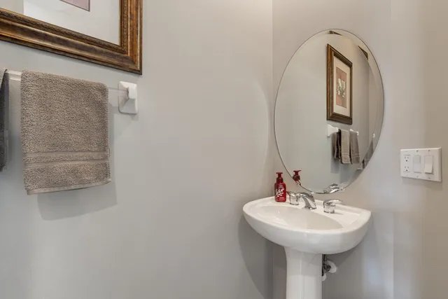 a bathroom with a sink a mirror and shower