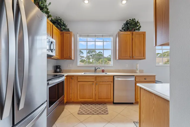 a kitchen with stainless steel appliances granite countertop a refrigerator sink and stove