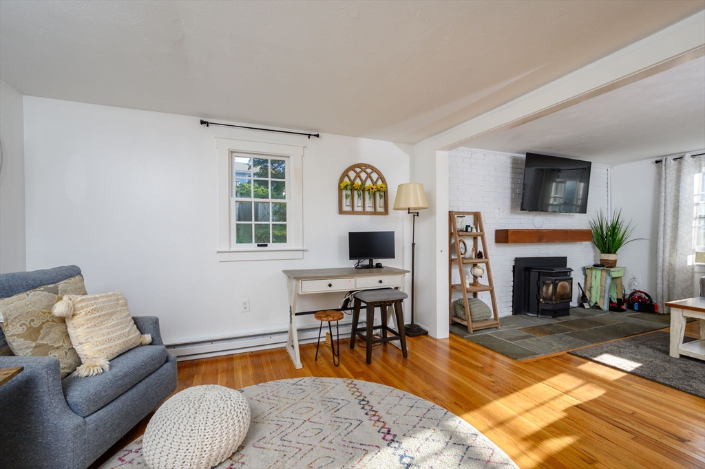 19 Langford Road Plymouth, MA 02360 - Photo 13 of 33 a living room with furniture a fireplace and a flat screen tv