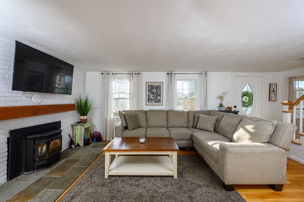 19 Langford Road Plymouth, MA 02360 - Photo 5 of 33 a living room with furniture a flat screen tv and a fireplace