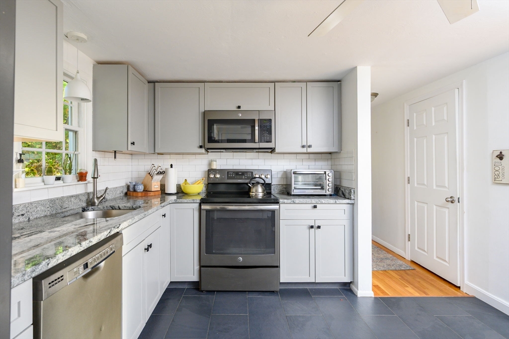 19 Langford Road Plymouth, MA 02360 - Photo 10 of 33 a kitchen with stainless steel appliances granite countertop a sink a stove a refrigerator a microwave and cabinets