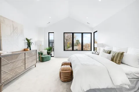 a bedroom with a large bed and a large window