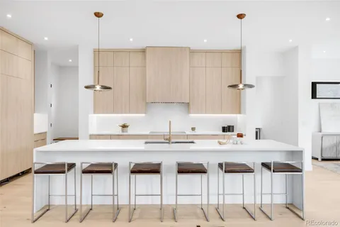 a kitchen with cabinets and chairs