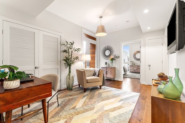 a living room with furniture a chandelier and a dining room