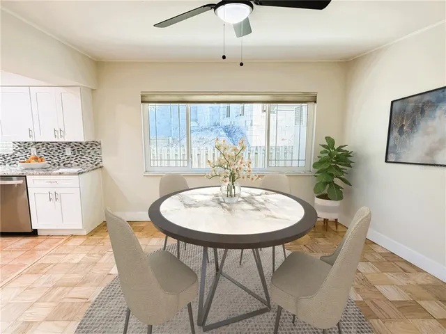 a dining room with furniture a chandelier and wooden floor