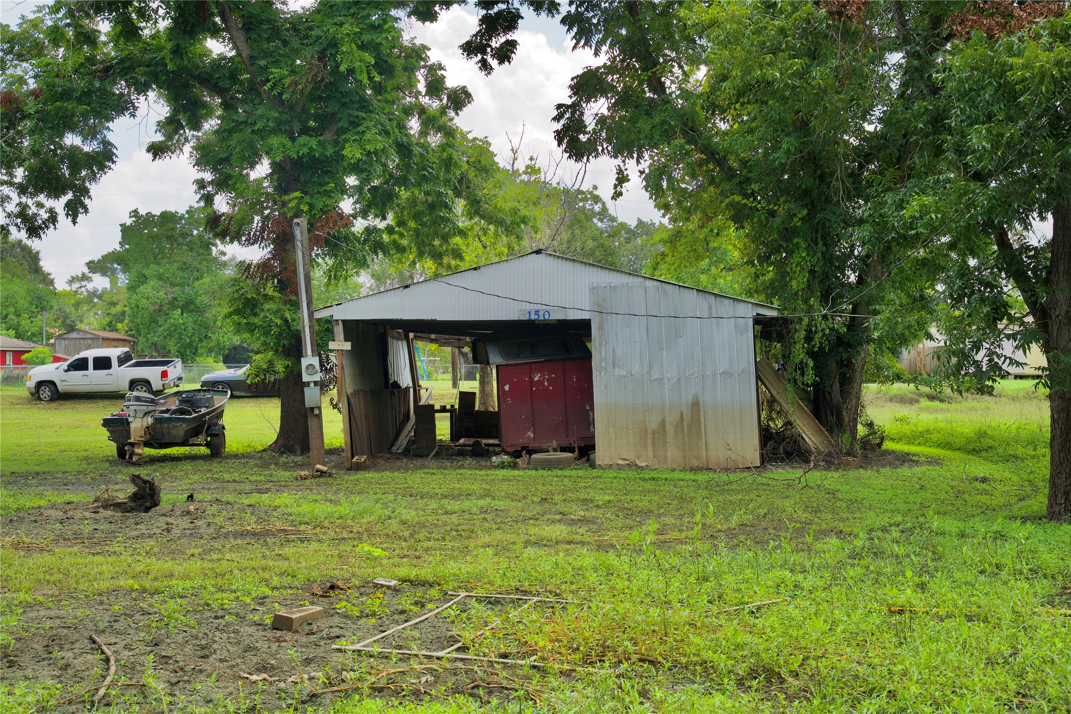 150 White Oak Drive Trinity, TX 75862 - Photo 3 of 3 a view of a fire pit in front of a big yard with large trees