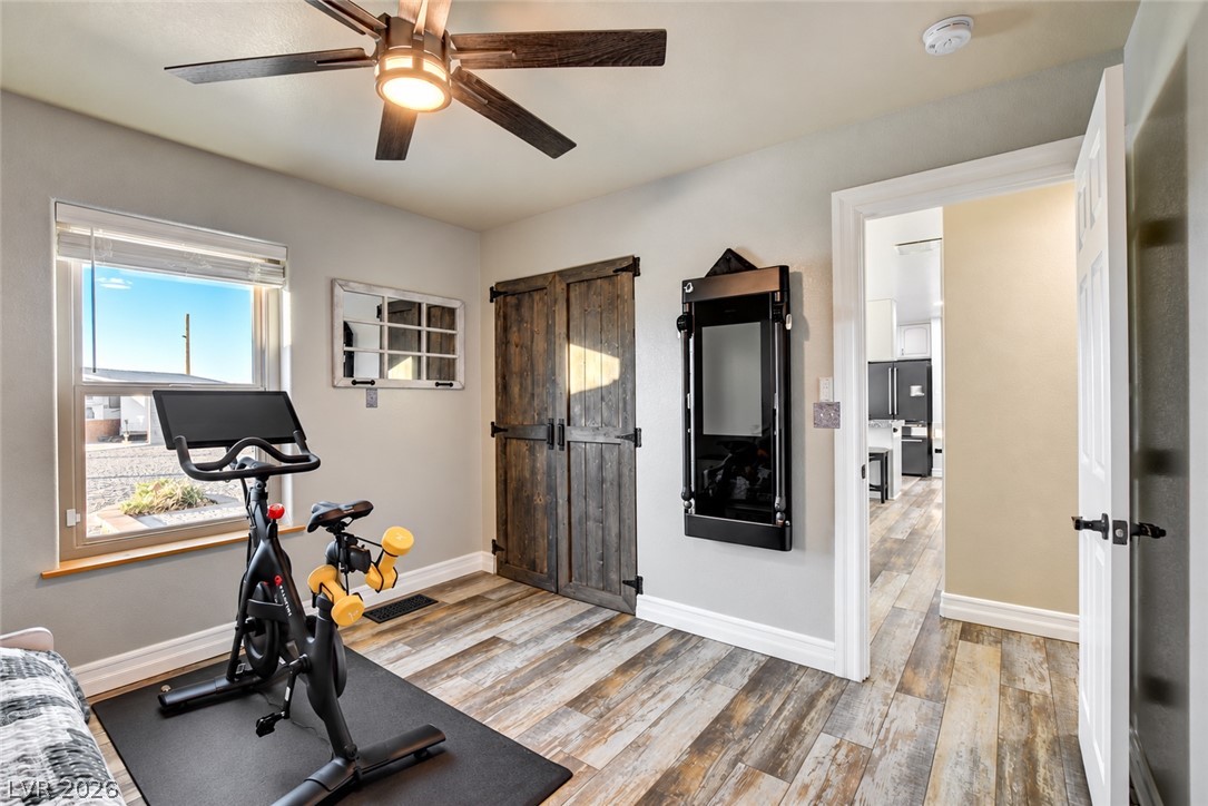 6460 Racel Street Las Vegas, NV 89131 - Photo 52 of 59 Gleaming wood-look floors complement rustic sliding doors in this versatile additional room.