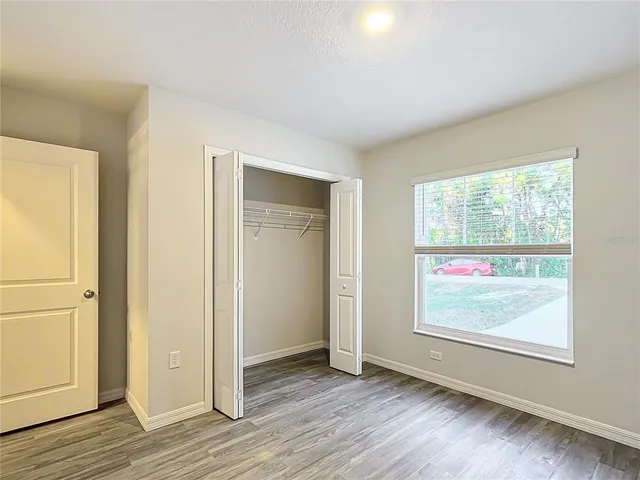 wooden floor in an empty room with a window