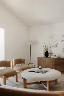 a living room with furniture and flowers