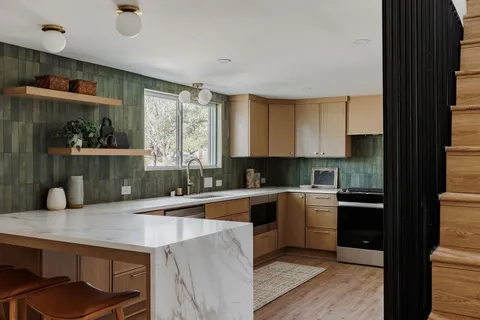 a kitchen with a sink a stove and cabinets