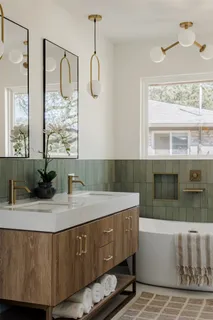 a bathroom with a granite countertop sink a mirror and shower