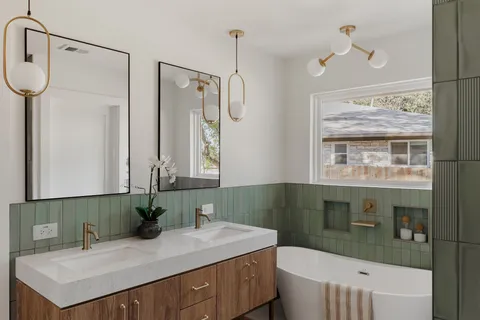 a bathroom with a sink a toilet and mirror