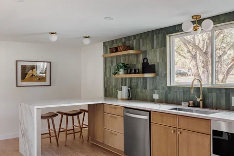a kitchen with a sink and a large window