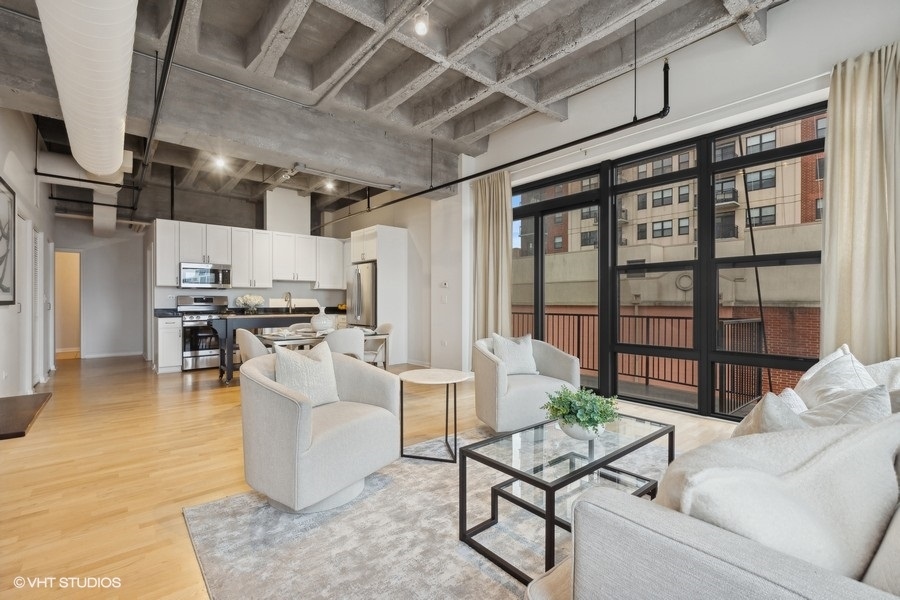 1503 South State Street, Unit 506 Chicago, IL 60605 - Photo 6 of 16 a living room with furniture and kitchen view