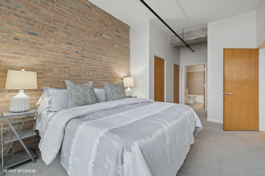 1503 South State Street, Unit 506 Chicago, IL 60605 - Photo 10 of 16 a bedroom with a bed and a lamp