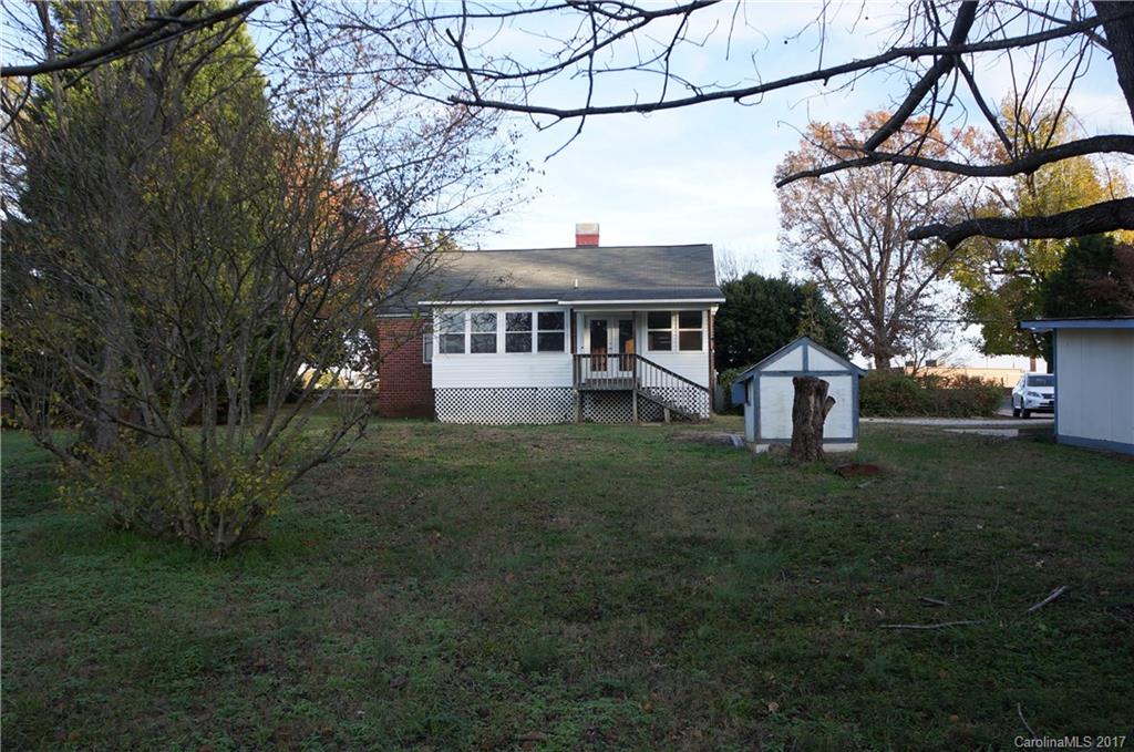 604 Banks Street Fort Mill, SC 29715 - Photo 15 of 16 a front view of a house with a garden and trees