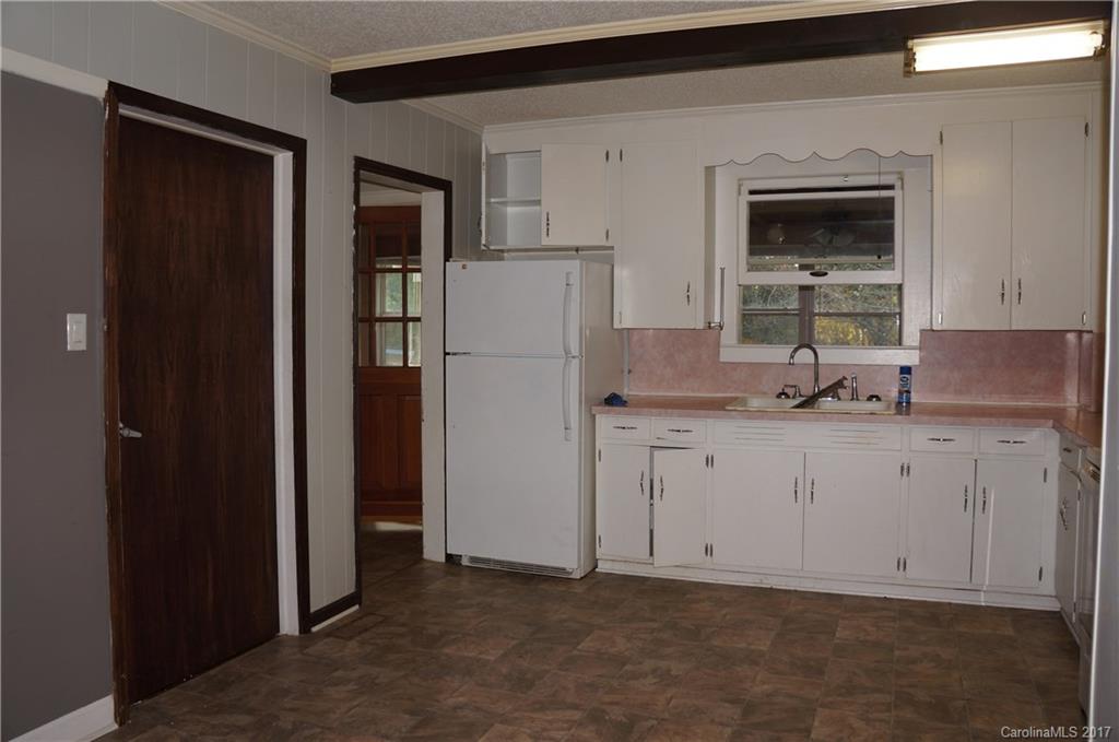 604 Banks Street Fort Mill, SC 29715 - Photo 4 of 16 a kitchen with granite countertop white cabinets and refrigerator
