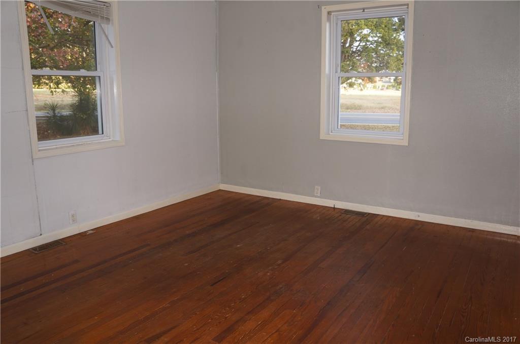 604 Banks Street Fort Mill, SC 29715 - Photo 7 of 16 an empty room with wooden floor and windows