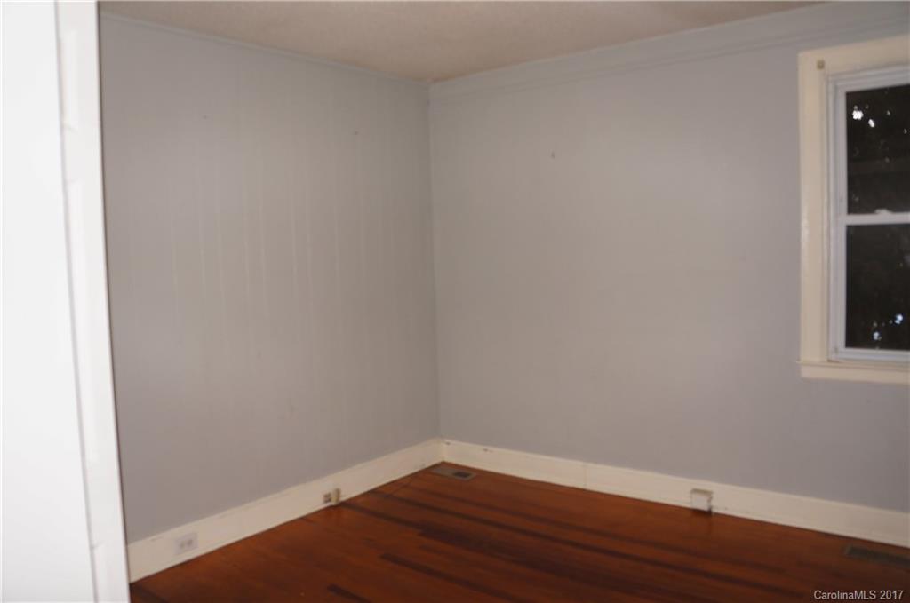 604 Banks Street Fort Mill, SC 29715 - Photo 8 of 16 a view of an empty room with wooden floor and a window