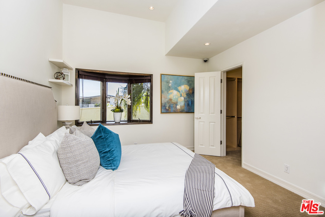 3612 Surfwood Road Malibu, CA 90265 - Photo 15 of 19 a bedroom with a large bed and a large window