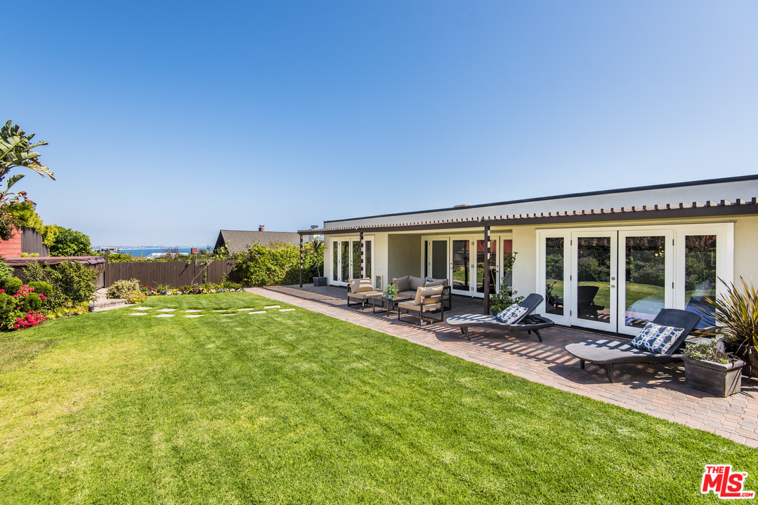 3612 Surfwood Road Malibu, CA 90265 - Photo 16 of 19 a view of a house with backyard porch and sitting area