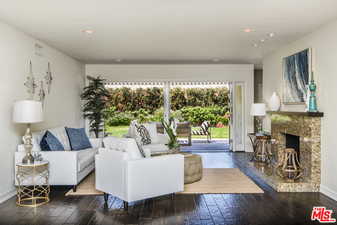 3612 Surfwood Road Malibu, CA 90265 - Photo 7 of 19 a living room with fireplace furniture and a large window
