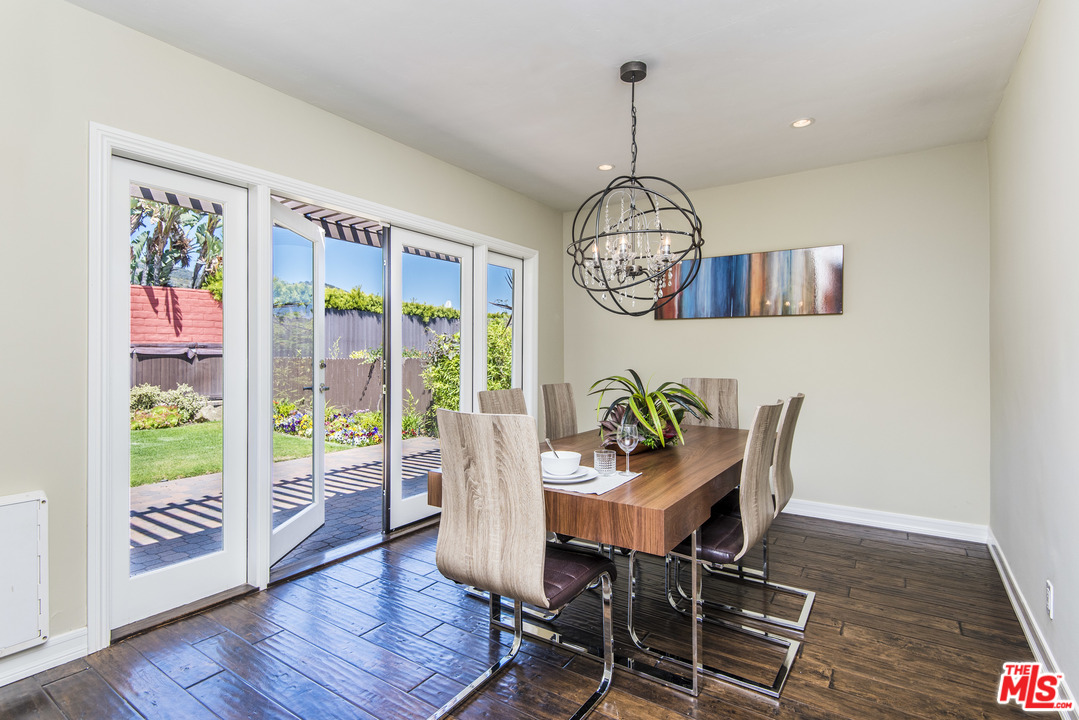 3612 Surfwood Road Malibu, CA 90265 - Photo 8 of 19 a view of a dining room with furniture wooden floor and chandelier